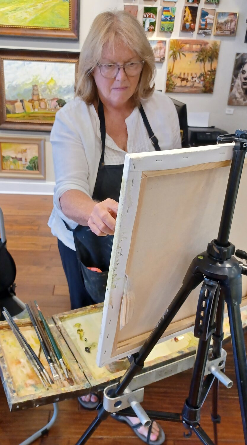 Martha Ferguson does a painting live during a special event at The Grand Bohemian Galley.
